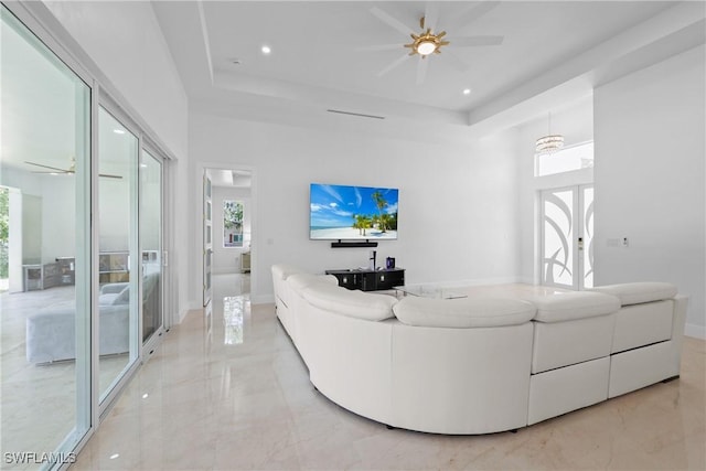 192 Herron Rd, North Fort Myers, FL 33903 - living area featuring french doors, light marble finish floors, a raised ceiling, ceiling fan, and a high ceiling