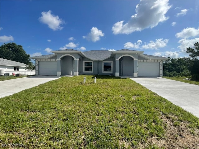 4532/4534 22nd St SW, Lehigh Acres, FL 33973 - single story home featuring driveway, a front lawn, an attached garage, and stucco siding