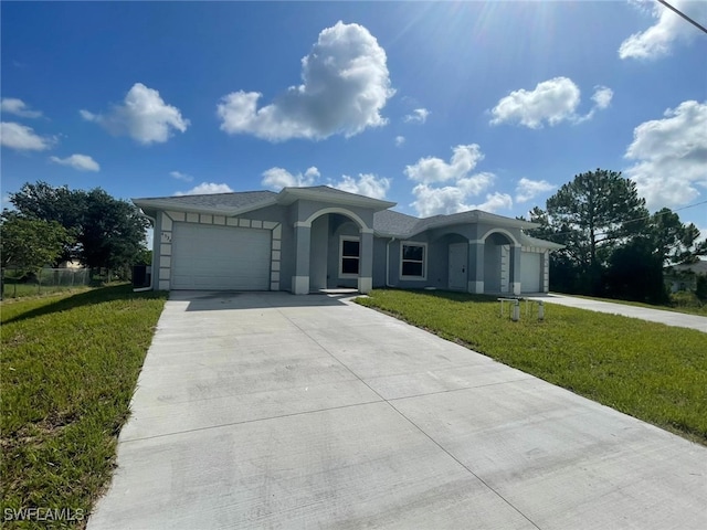 4532/4534 22nd St SW, Lehigh Acres, FL 33973 - ranch-style house featuring an attached garage, concrete driveway, a front lawn, and stucco siding
