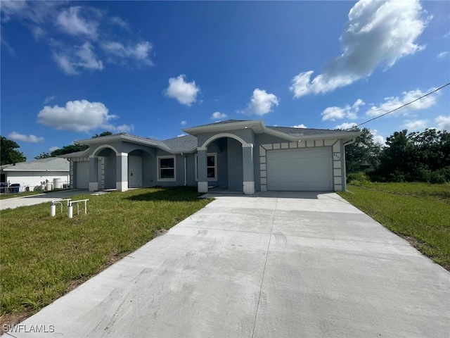 4532/4534 22nd St SW, Lehigh Acres, FL 33973 - ranch-style home featuring a garage, concrete driveway, a front yard, and stucco siding