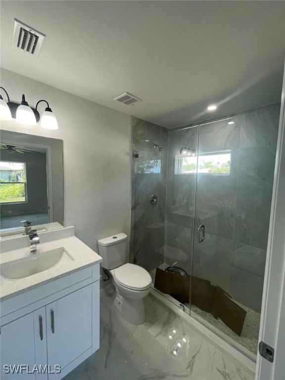 4532/4534 22nd St SW, Lehigh Acres, FL 33973 - full bathroom featuring vanity, a shower stall, and marble look tile flooring