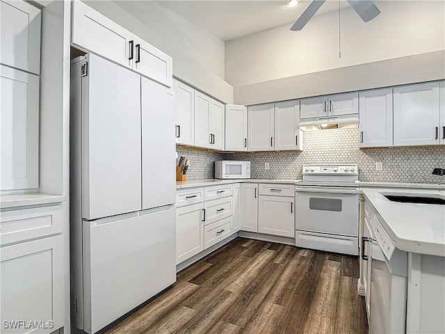 20698 Marathona Ct, North Fort Myers, FL 33917 - kitchen featuring white appliances, dark wood-type flooring, light countertops, ceiling fan, and backsplash