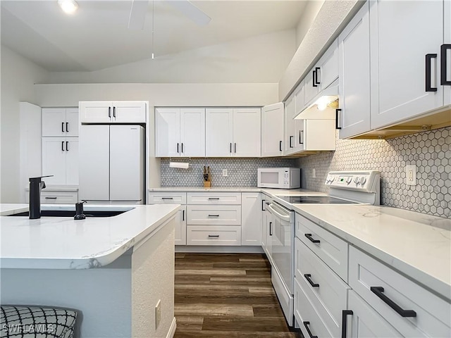 20698 Marathona Ct, North Fort Myers, FL 33917 - kitchen featuring white appliances, dark wood finished floors, tasteful backsplash, white cabinets, and light stone counters