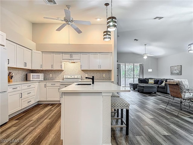 20698 Marathona Ct, North Fort Myers, FL 33917 - kitchen featuring a ceiling fan, dark wood finished floors, tasteful backsplash, light countertops, and high vaulted ceiling