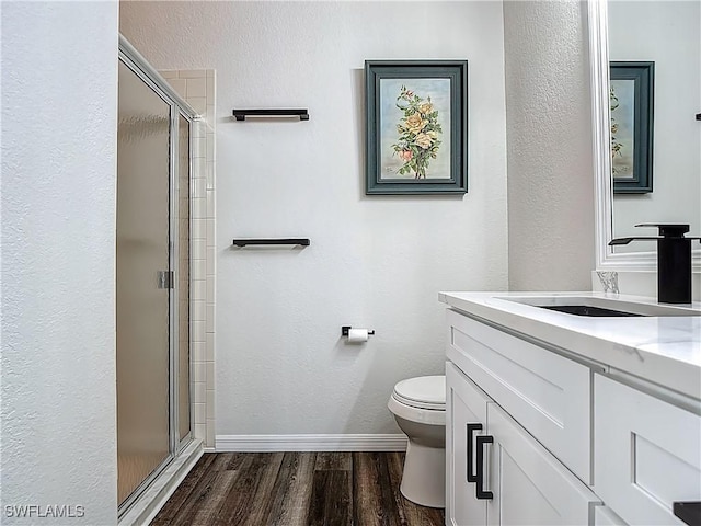 20698 Marathona Ct, North Fort Myers, FL 33917 - bathroom featuring a stall shower, vanity, wood finished floors, and a textured wall