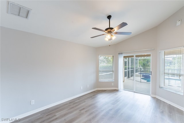 4200 SW 3rd Ave, Cape Coral, FL 33914 - empty room with vaulted ceiling, wood finished floors, and a ceiling fan