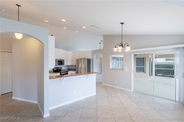 4200 SW 3rd Ave, Cape Coral, FL 33914 - kitchen featuring appliances with stainless steel finishes, arched walkways, vaulted ceiling, a peninsula, and a kitchen breakfast bar