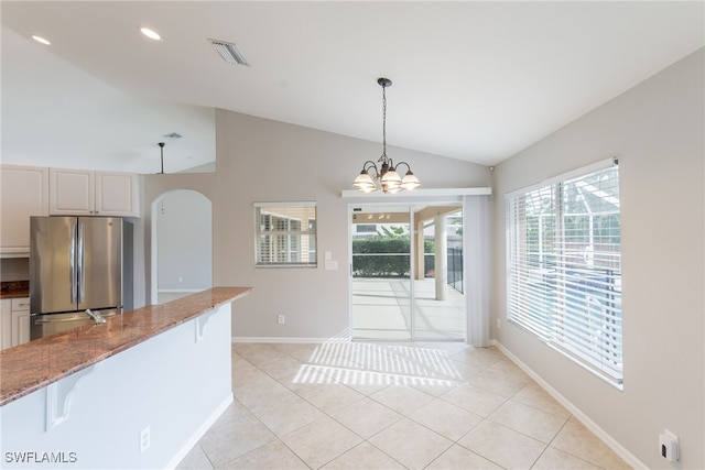 4200 SW 3rd Ave, Cape Coral, FL 33914 - unfurnished dining area featuring vaulted ceiling, arched walkways, light tile patterned floors, recessed lighting, and a chandelier