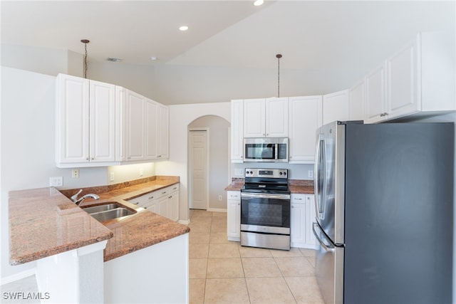 4200 SW 3rd Ave, Cape Coral, FL 33914 - kitchen with stainless steel appliances, a peninsula, light stone counters, arched walkways, and white cabinetry