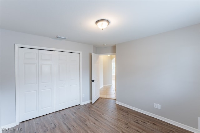 4200 SW 3rd Ave, Cape Coral, FL 33914 - unfurnished bedroom with a closet and wood finished floors