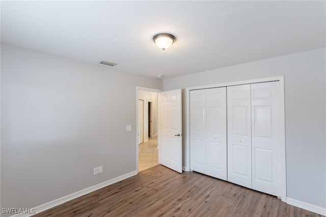 4200 SW 3rd Ave, Cape Coral, FL 33914 - unfurnished bedroom with wood finished floors and a closet
