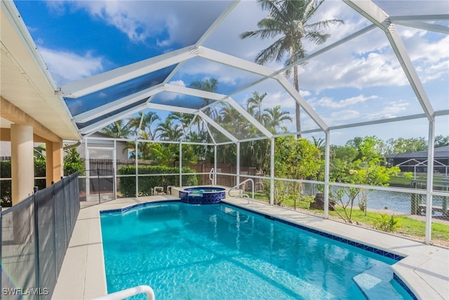 4200 SW 3rd Ave, Cape Coral, FL 33914 - view of swimming pool featuring glass enclosure, a pool with connected hot tub, a patio, and a water view