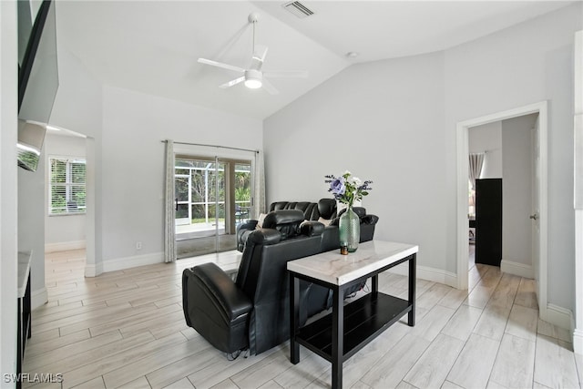 2711 4th St NW, Naples, FL 34120 - living room featuring vaulted ceiling, ceiling fan, and wood tiled floors