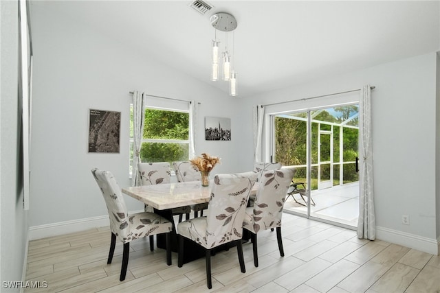 2711 4th St NW, Naples, FL 34120 - dining space featuring lofted ceiling and light wood-style flooring