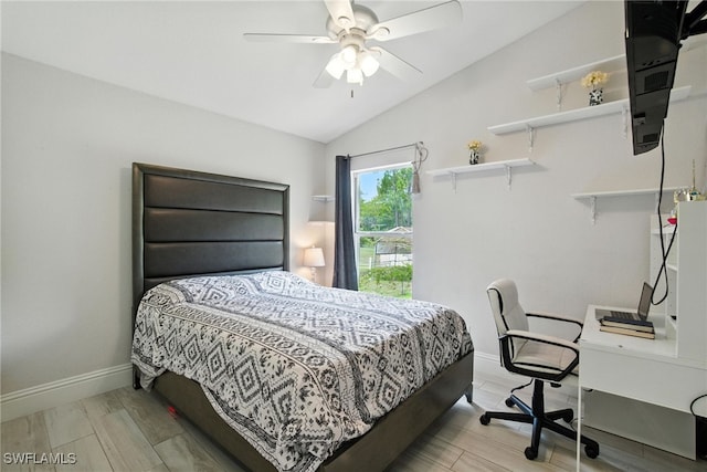 2711 4th St NW, Naples, FL 34120 - bedroom with lofted ceiling, a desk, a ceiling fan, and light wood-style floors
