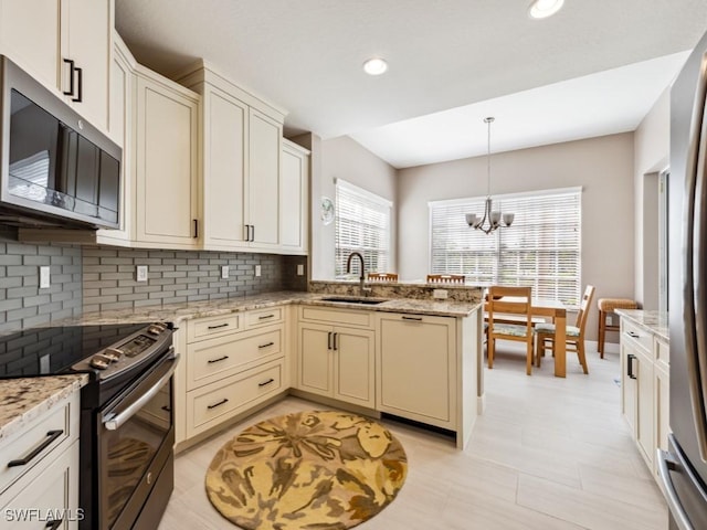 26690 Egrets Landing Dr Unit 101, Bonita Springs, FL 34134 - kitchen with appliances with stainless steel finishes, backsplash, a peninsula, pendant lighting, and recessed lighting