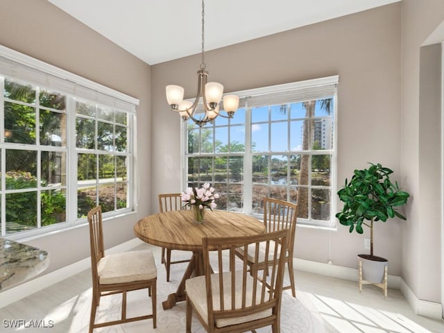 26690 Egrets Landing Dr Unit 101, Bonita Springs, FL 34134 - dining space featuring a chandelier and baseboards