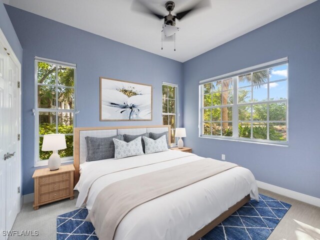 26690 Egrets Landing Dr Unit 101, Bonita Springs, FL 34134 - carpeted bedroom featuring multiple windows and a ceiling fan
