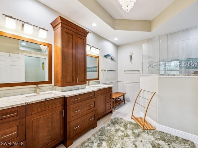 26690 Egrets Landing Dr Unit 101, Bonita Springs, FL 34134 - full bathroom featuring double vanity, walk in shower, a chandelier, recessed lighting, and a wainscoted wall