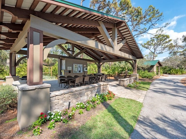 26690 Egrets Landing Dr Unit 101, Bonita Springs, FL 34134 - surrounding community featuring a gazebo, a patio area, and outdoor dining space