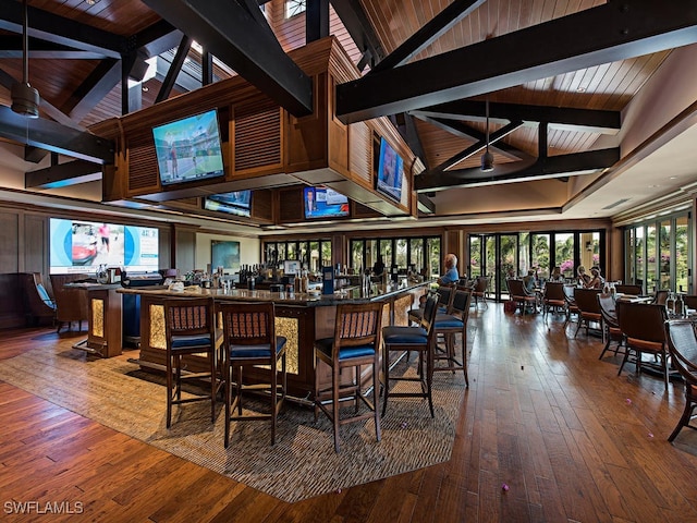 26690 Egrets Landing Dr Unit 101, Bonita Springs, FL 34134 - bar featuring hardwood / wood-style flooring, high vaulted ceiling, and beam ceiling