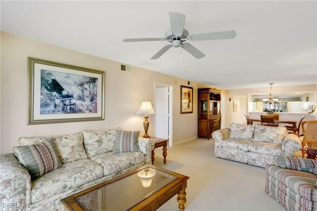 2396 Hidden Lake Dr Unit 3, Naples, FL 34112 - living room with light carpet, a ceiling fan, and a chandelier