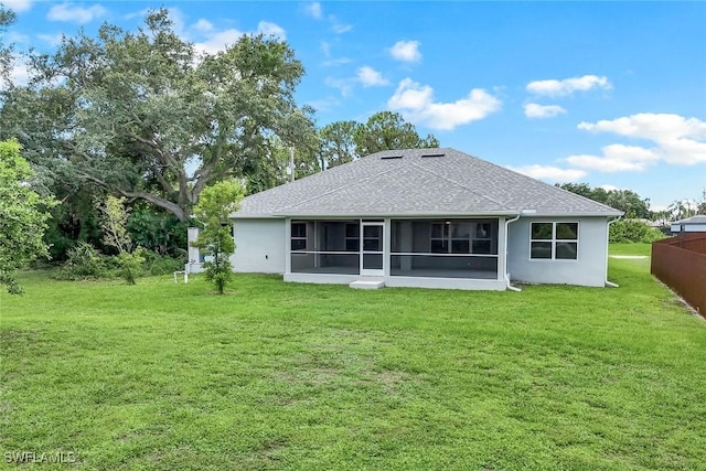 3457 NE 18th Pl, Cape Coral, FL 33909 - rear view of house with a lawn, a sunroom, roof with shingles, and stucco siding