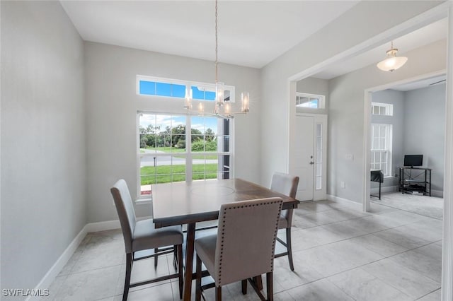 3457 NE 18th Pl, Cape Coral, FL 33909 - dining area with a chandelier and light tile patterned floors