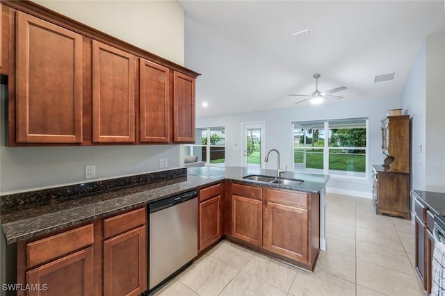 3457 NE 18th Pl, Cape Coral, FL 33909 - kitchen with dishwasher, a peninsula, ceiling fan, dark stone countertops, and light tile patterned floors