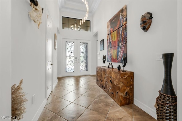 3910 Glacier Ct, Naples, FL 34119 - entryway featuring crown molding, french doors, tile patterned floors, a high ceiling, and a chandelier