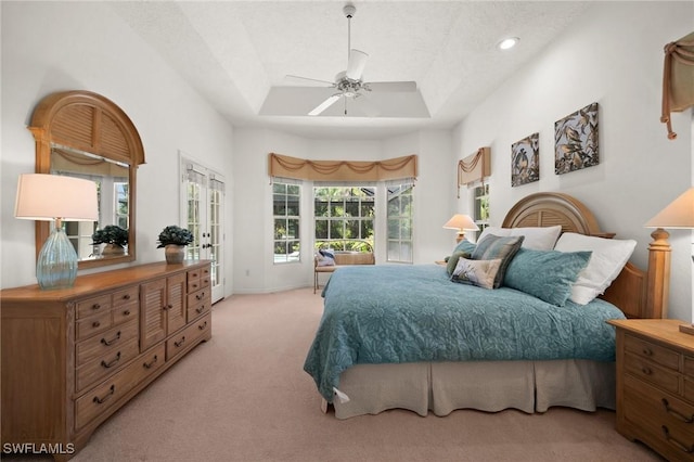 24881 Pennyroyal Dr, Bonita Springs, FL 34134 - bedroom with light carpet, a tray ceiling, access to exterior, and a ceiling fan