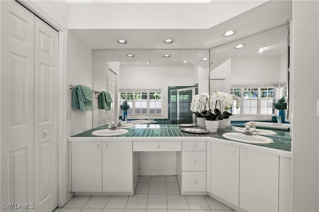 24881 Pennyroyal Dr, Bonita Springs, FL 34134 - bathroom featuring recessed lighting, double vanity, a closet, a stall shower, and tile patterned floors