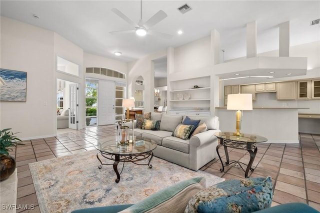 24881 Pennyroyal Dr, Bonita Springs, FL 34134 - living room with a towering ceiling, a ceiling fan, light tile patterned floors, arched walkways, and recessed lighting