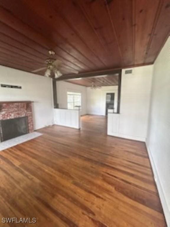 539 E Pasadena Ave, Clewiston, FL 33440 - unfurnished living room with wooden ceiling, wood finished floors, and a fireplace with flush hearth