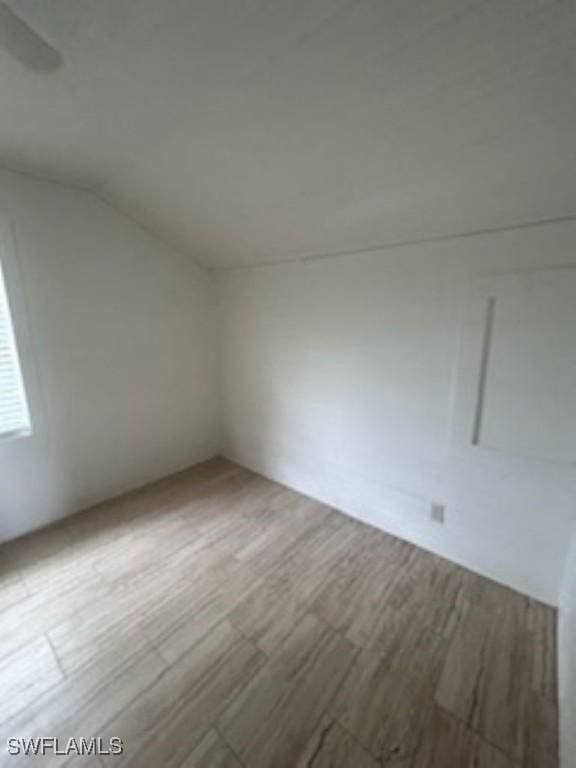 539 E Pasadena Ave, Clewiston, FL 33440 - empty room featuring lofted ceiling and wood finished floors