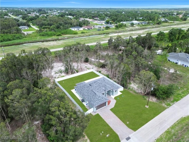 4205 Nora Ave S, Lehigh Acres, FL 33976 - view from above of property with a tree filled landscape