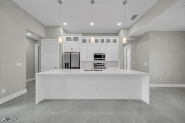 4205 Nora Ave S, Lehigh Acres, FL 33976 - kitchen featuring appliances with stainless steel finishes, a large island, white cabinetry, light countertops, and glass insert cabinets