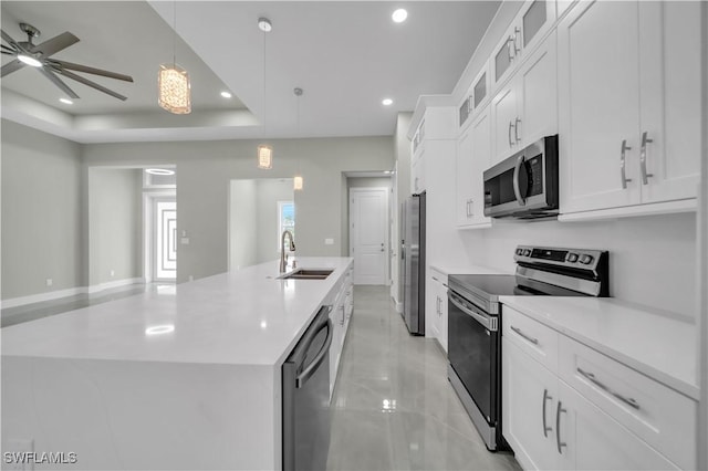 4205 Nora Ave S, Lehigh Acres, FL 33976 - kitchen with stainless steel appliances, a kitchen island with sink, a ceiling fan, light countertops, and recessed lighting