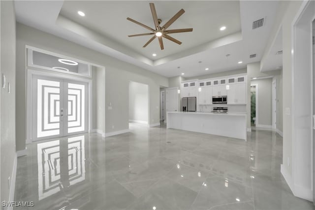 4205 Nora Ave S, Lehigh Acres, FL 33976 - unfurnished living room featuring a ceiling fan, recessed lighting, and a raised ceiling