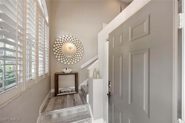 2450 Old Groves Rd Unit 201, Naples, FL 34109 - entryway featuring wood finished floors and stairway