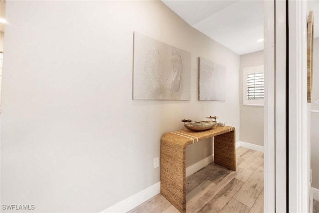 2450 Old Groves Rd Unit 201, Naples, FL 34109 - hallway featuring light wood-style flooring