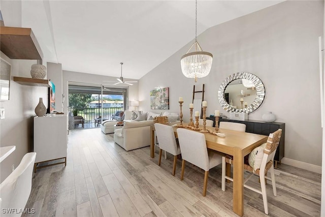 2450 Old Groves Rd Unit 201, Naples, FL 34109 - dining space with light wood-type flooring, a chandelier, high vaulted ceiling, and ceiling fan