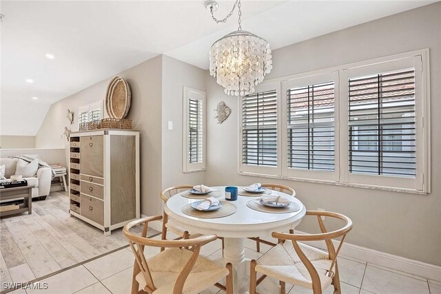 2450 Old Groves Rd Unit 201, Naples, FL 34109 - dining room featuring plenty of natural light and a chandelier