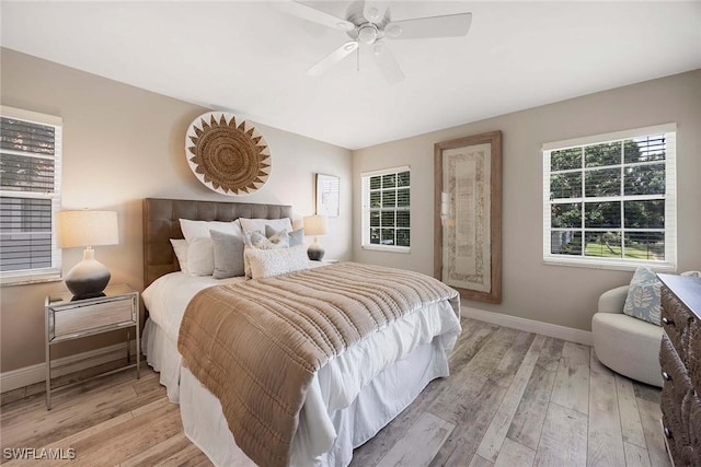 2450 Old Groves Rd Unit 201, Naples, FL 34109 - bedroom featuring light wood-type flooring and ceiling fan