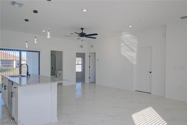 2107 Jefferson Ave, Alva, FL 33920 - kitchen with open floor plan, plenty of natural light, white cabinets, light stone counters, and recessed lighting