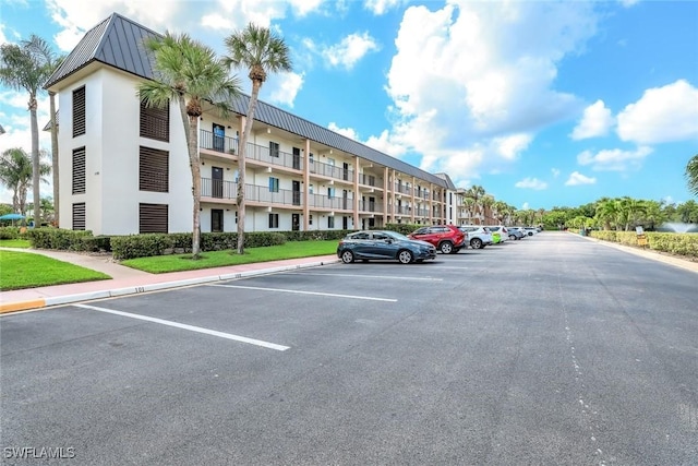 1000 Manatee Rd Unit A306, Naples, FL 34114 - view of apartment building / complex featuring uncovered parking