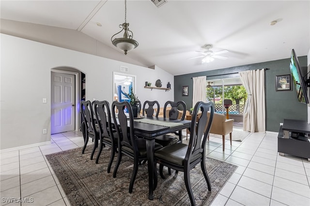 5421/5423 Centennial Blvd, Lehigh Acres, FL 33971 - dining area featuring a ceiling fan, light tile patterned flooring, arched walkways, and vaulted ceiling