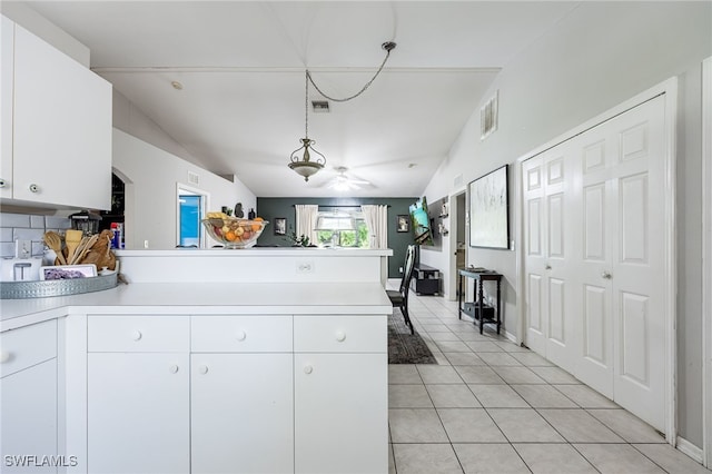 5421/5423 Centennial Blvd, Lehigh Acres, FL 33971 - kitchen with a peninsula, light countertops, light tile patterned floors, white cabinetry, and decorative light fixtures