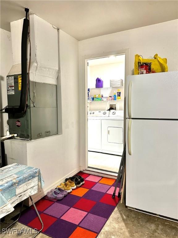 2675 70th Ave NE, Naples, FL 34120 - kitchen featuring freestanding refrigerator, washing machine and clothes dryer, and heating unit