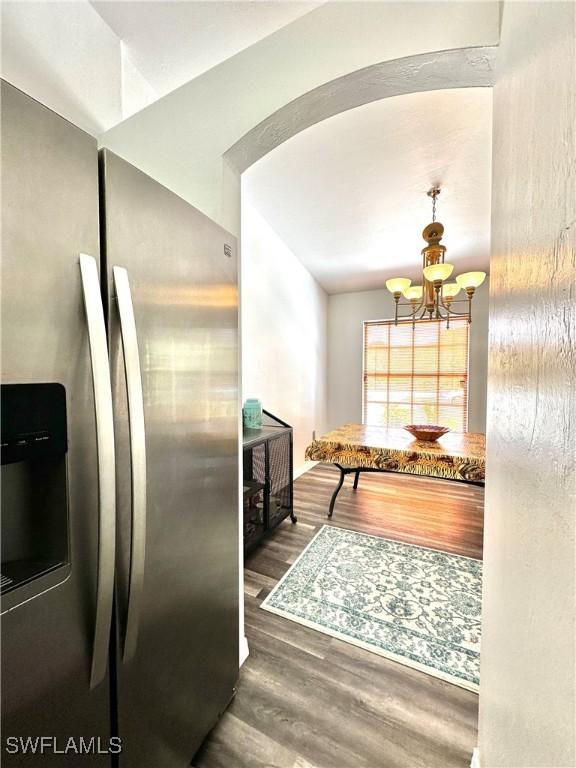 2675 70th Ave NE, Naples, FL 34120 - kitchen with stainless steel fridge with ice dispenser, wood finished floors, and a chandelier